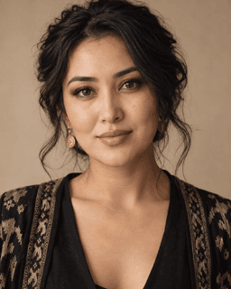 Nadia Karimova, a makeup artist in a warm neutral studio portrait.
