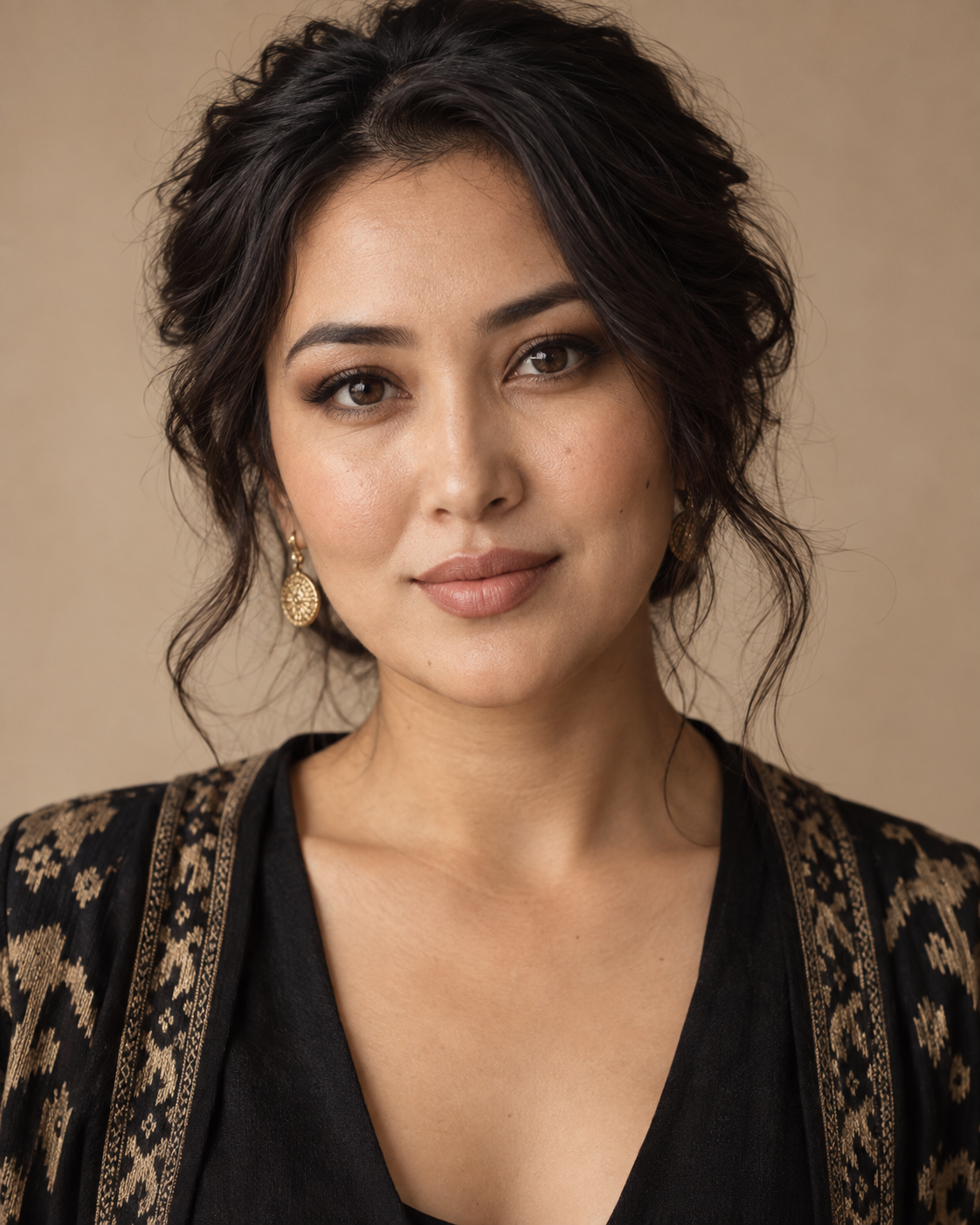 Nadia Karimova, a makeup artist in a warm neutral studio portrait.
